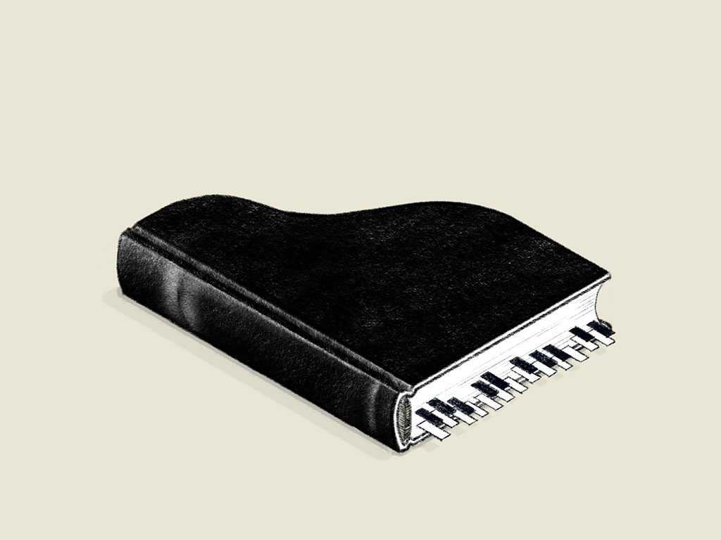 Un libro negro con forma de piano y marcadores de página imitando las teclas.